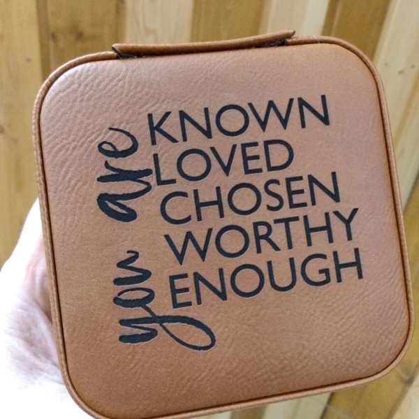 Tan square gift box with the words "known loved chosen worthy enough"