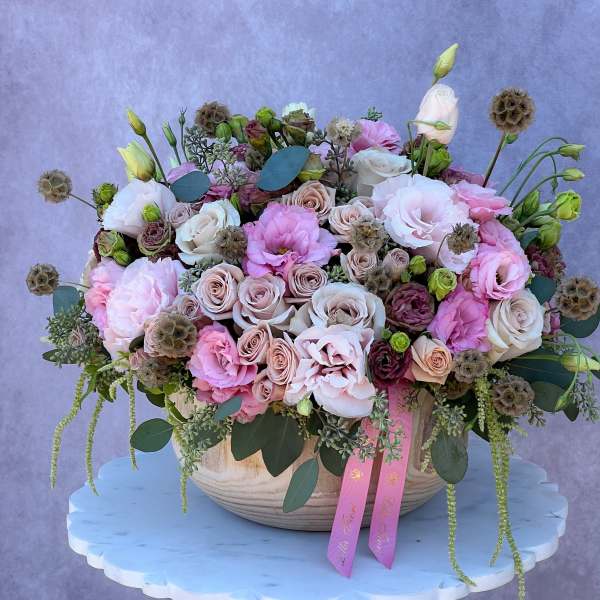 Large pastel flower arrangement in a ceramic bowl with pink and white blooms