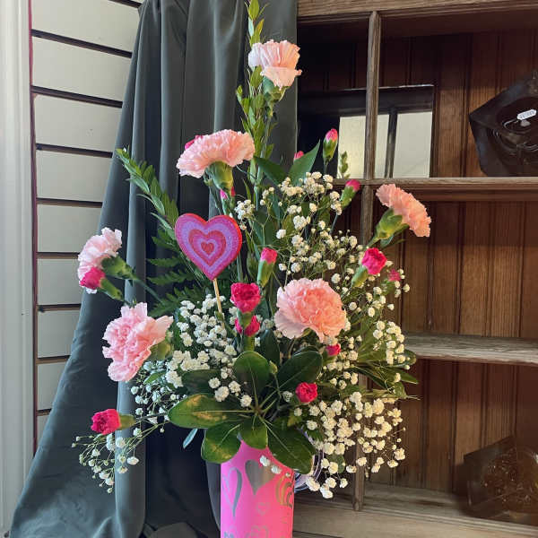 Pink carnations and baby's breath in a pink heart vase