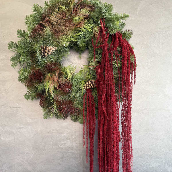 Evergreen wreath with pinecones and long red hanging amaranthus