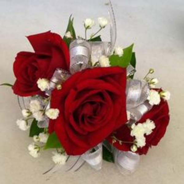 Red roses with white filler flowers and silver ribbon accents