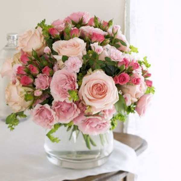 Pink and blush rose bouquet in a clear glass vase