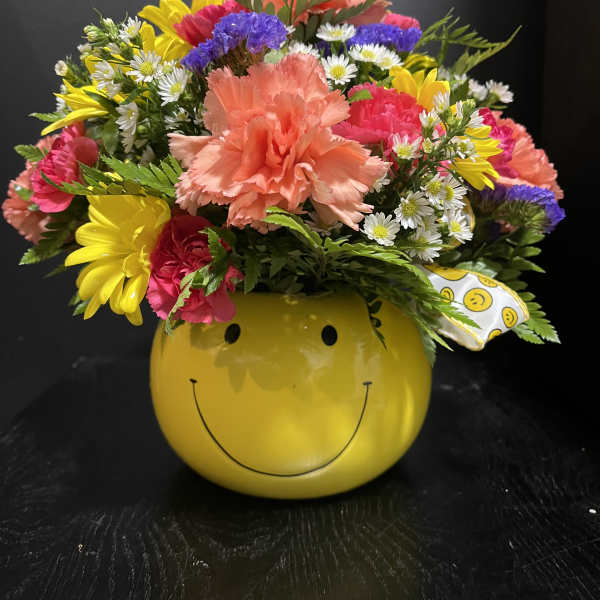Colorful mixed bouquet in a yellow smiley-face container
