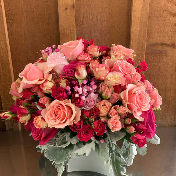 Pink and red rose bouquet in a white vase