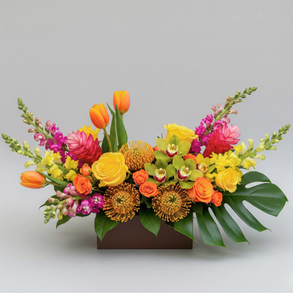 Bright mixed floral arrangement in a rectangular box with tulips and roses