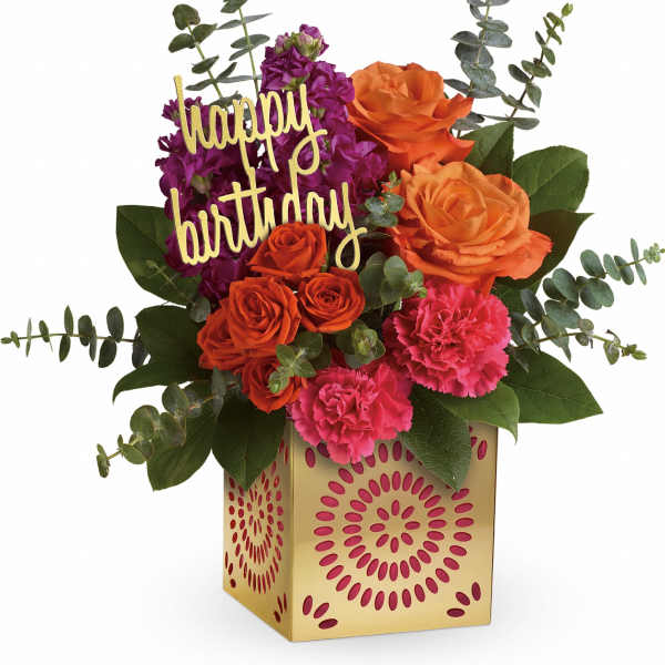 Birthday flower arrangement with roses, carnations, and a happy birthday sign
