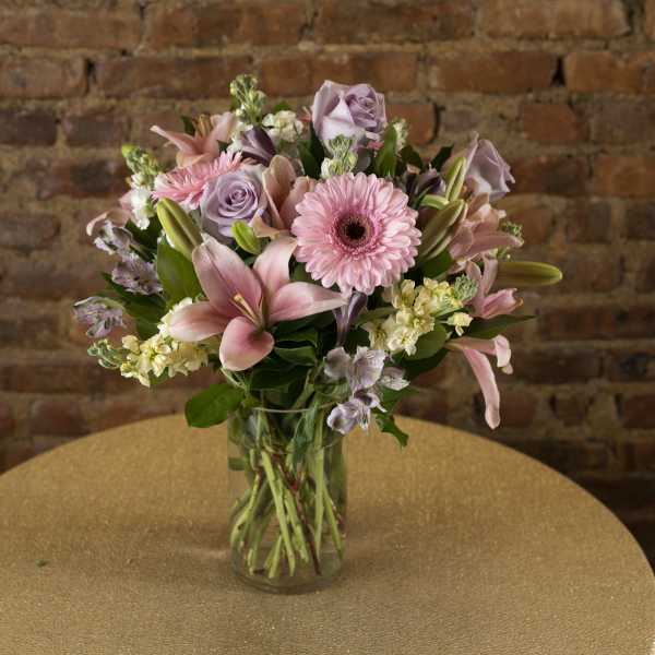 Pink and lavender mixed bouquet in a clear glass vase