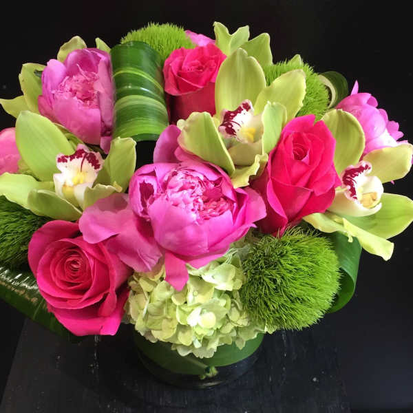 Pink roses and peonies with green orchids in a low arrangement
