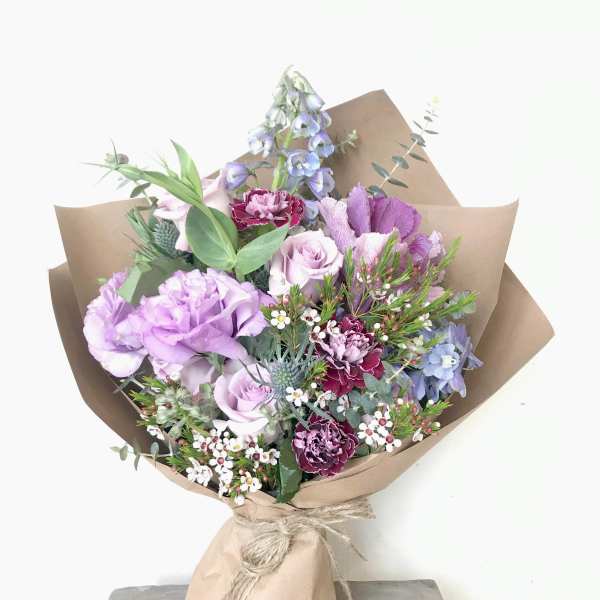 Lavender and pink mixed bouquet wrapped in brown paper