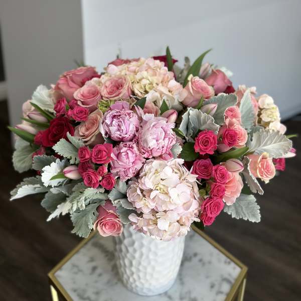 Pink roses and hydrangeas in a white vase