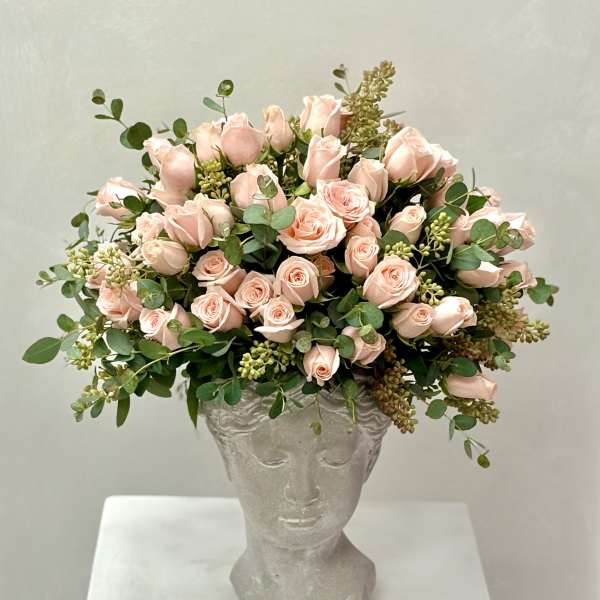 Pink rose bouquet in a sculpted gray vase