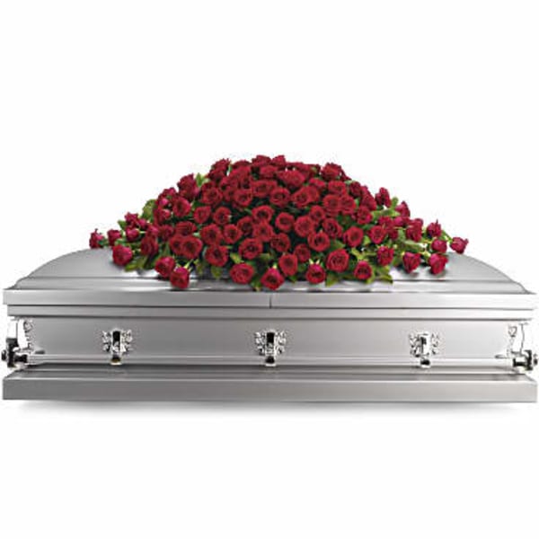 Red rose casket spray on a silver casket