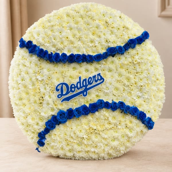 Baseball-shaped floral arrangement with white flowers and blue rose accents