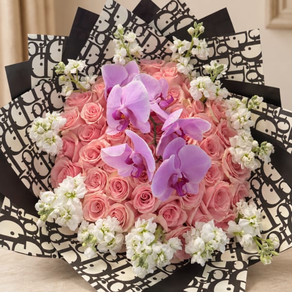 Pink rose bouquet with purple orchids and white accent flowers