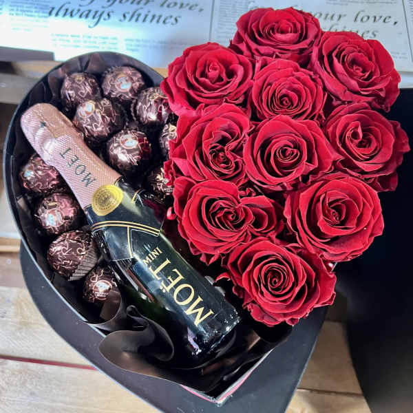 Heart-shaped box with red roses, chocolates, and a mini Moet bottle