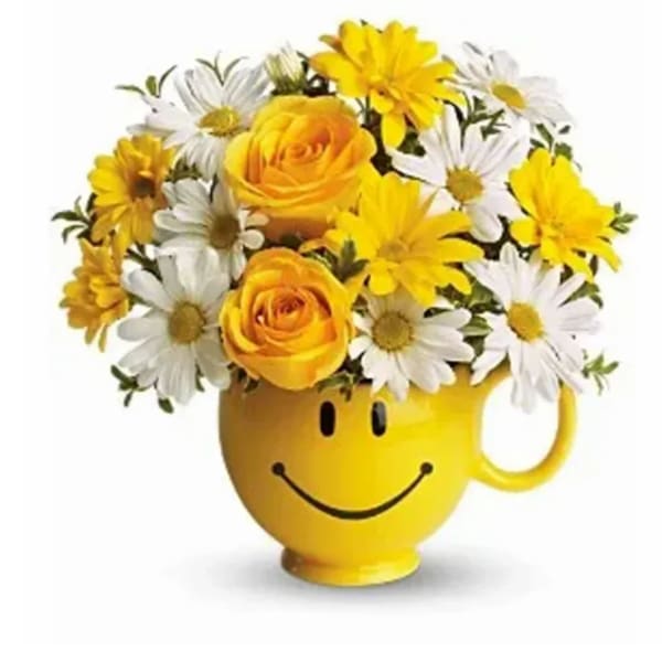 Yellow smiley-face mug holding yellow roses and white daisies