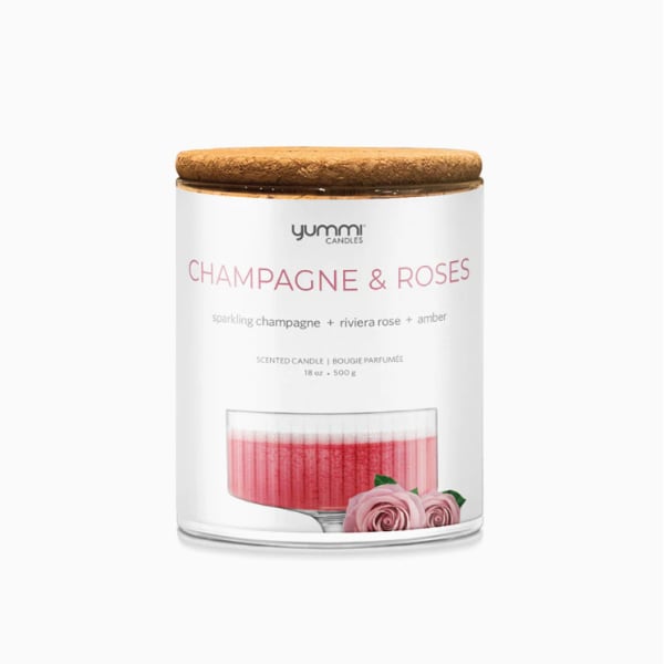 Scented candle in a glass jar with a cork lid and pink label