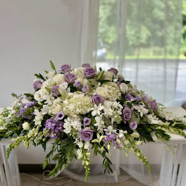 Lavender and white floral arrangement spread across a table