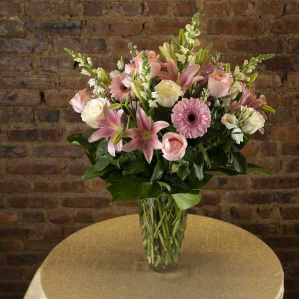 Pink and white mixed flower bouquet in a clear glass vase