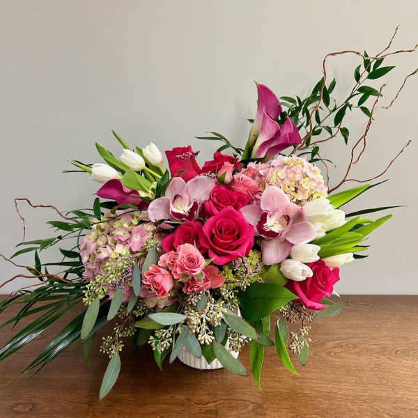 Pink and white floral arrangement in a white vase