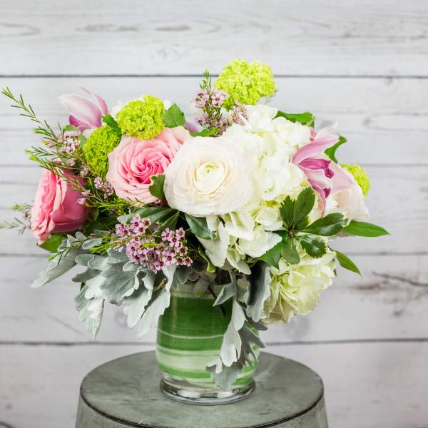 Pink and white mixed flower arrangement in a glass vase