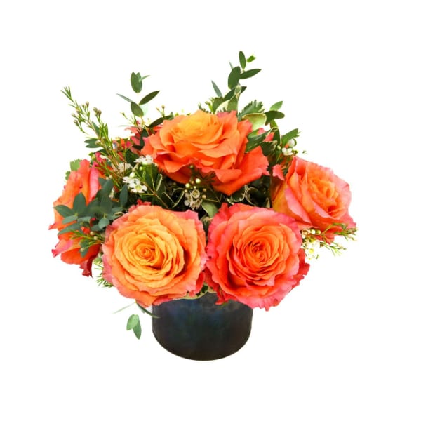 Orange rose arrangement in a black vase