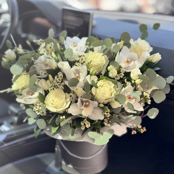 White rose and orchid bouquet in a round box