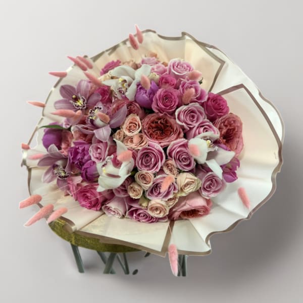 Pink and lavender rose bouquet wrapped in cream paper