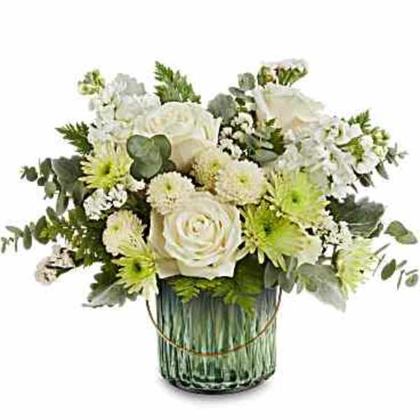 White and green floral arrangement in a glass vase