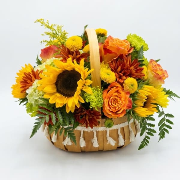 Basket arrangement with sunflowers, orange roses, and chrysanthemums