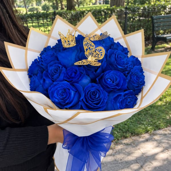 Bouquet of blue roses wrapped in white paper with gold trim