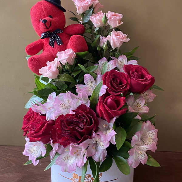 Red teddy bear with pink roses and red roses in a white box