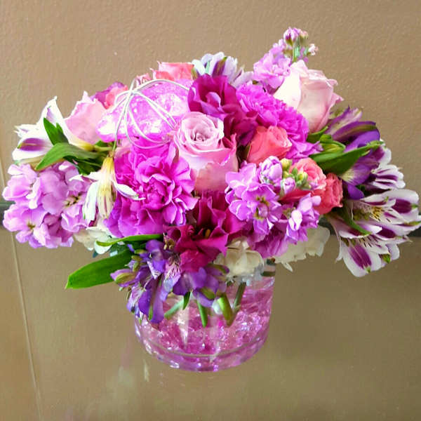 Pink and purple bouquet in a clear glass vase