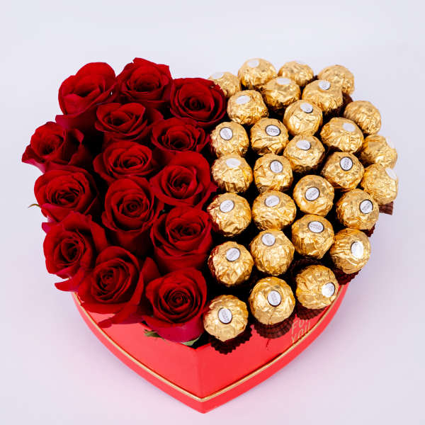 Heart-shaped box with red roses and gold-wrapped chocolates