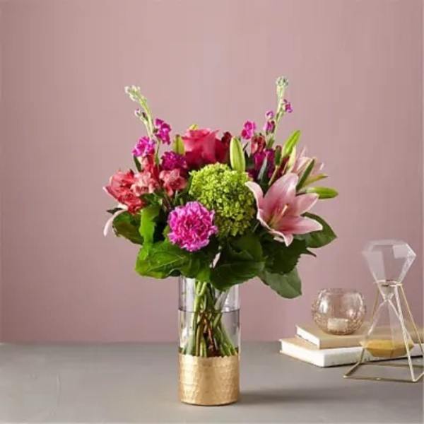 Pink and purple mixed bouquet in a clear glass vase