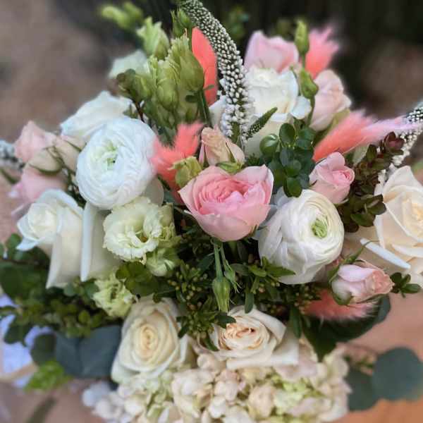 Bouquet of pink and white flowers with green accents