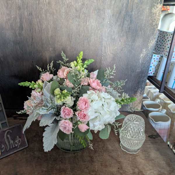 Pink and white floral arrangement in a glass vase