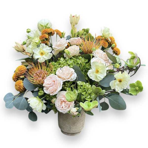 Mixed bouquet in a gray vase with pale pink and white blooms