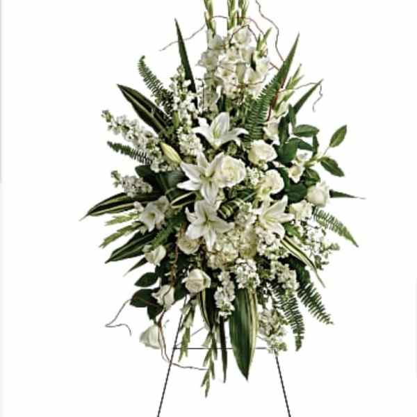 Tall white floral standing spray on an easel