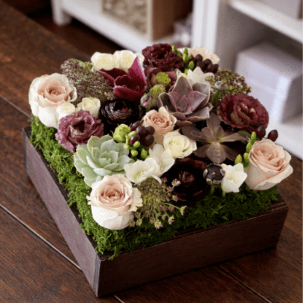 Succulent and rose arrangement in a wooden box