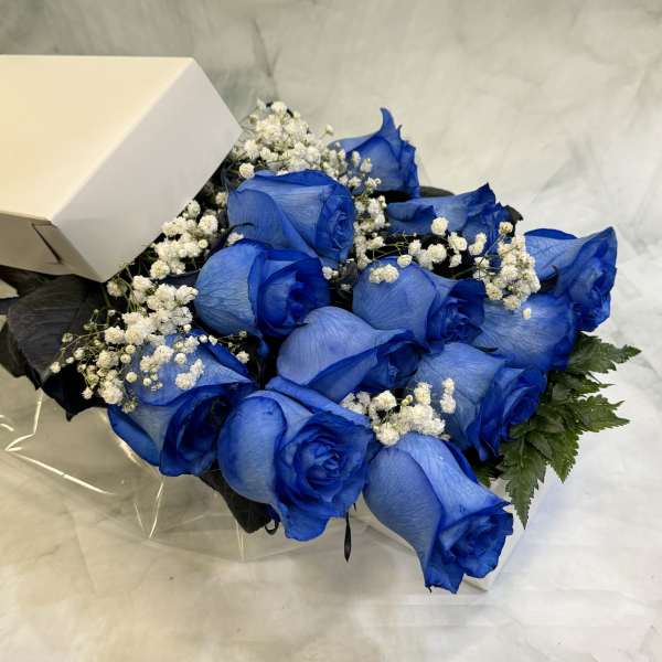 Bouquet of blue roses with white baby's breath in a box