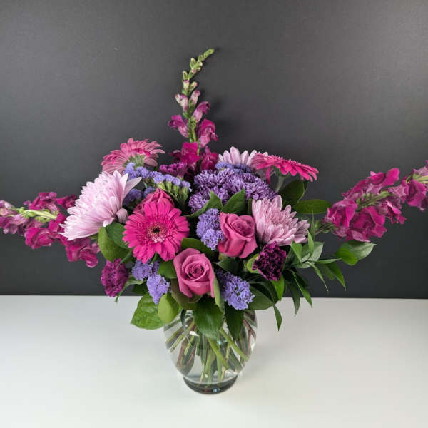 Pink and purple mixed bouquet in a clear glass vase