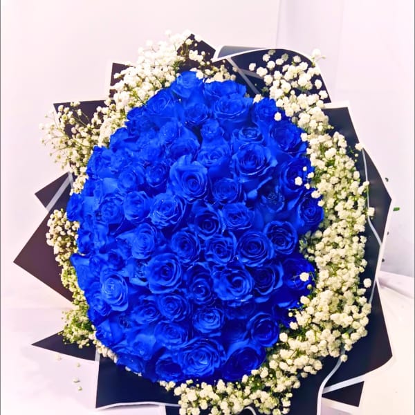 Bouquet of vivid blue roses with white baby's breath