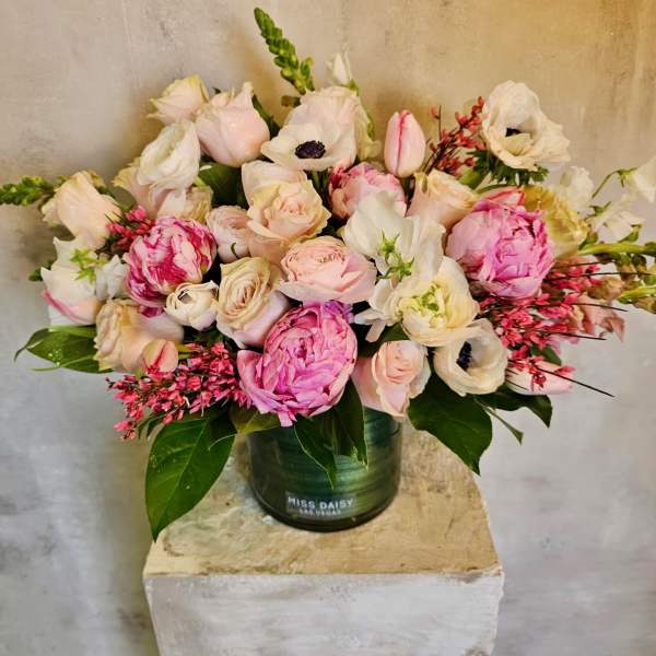 Pink and white flower arrangement in a green vase