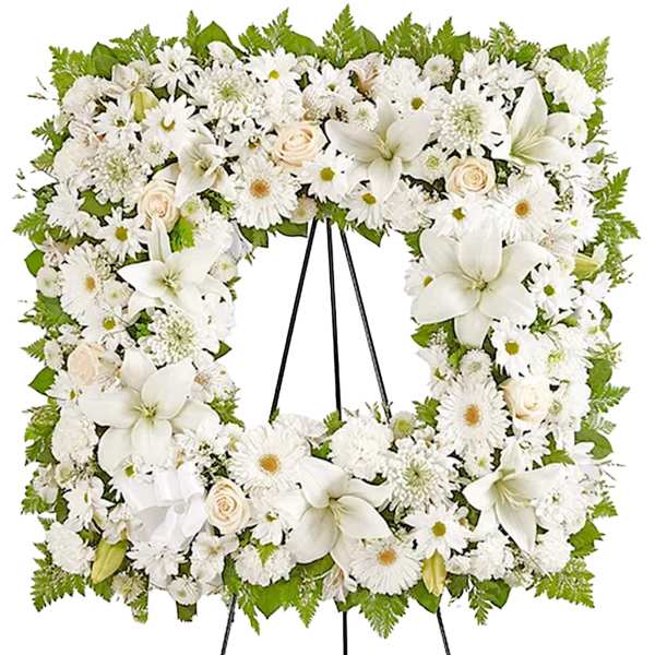 White floral funeral wreath on a black easel