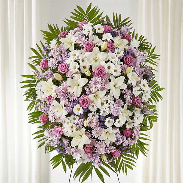 Large standing floral spray with pink, white, and lavender blooms