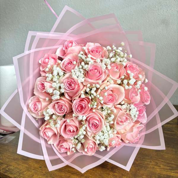 Pink rose bouquet wrapped in translucent pink paper