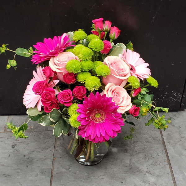 Pink and green mixed bouquet in a glass vase