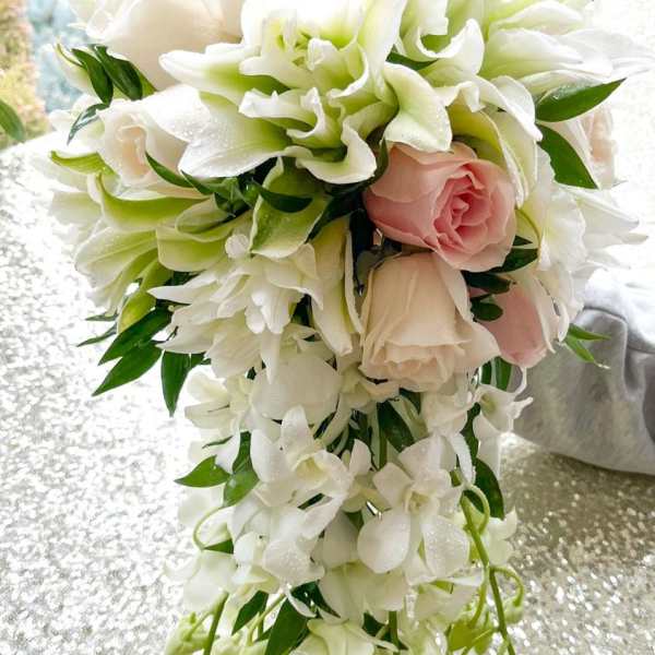 Cascade bouquet of white and blush flowers with trailing greenery