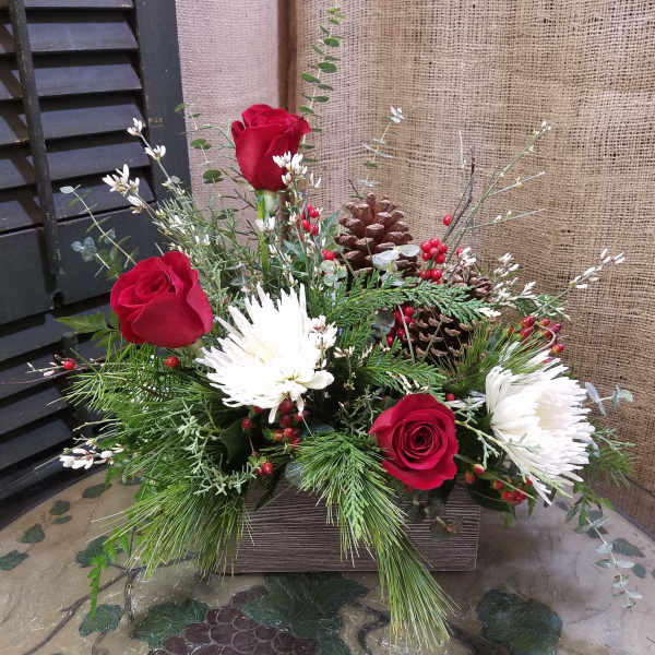 Red roses and white chrysanthemums in a rustic wooden box